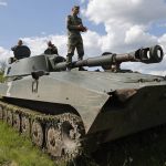 
              A crew of self-propelled artillery vehicles 'Gvozdika' ('Carnation') of Donetsk People's Republic militia prepare to fire towards Ukrainian army position, near the town of Yasynuvataya, outside Donetsk, in territory under the government of the Donetsk People's Republic, eastern Ukraine, Friday, May 20, 2022. (AP Photo/Alexei Alexandrov)
            