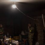 
              Ukrainian Territorial Defence Force members gather in a basement during a deployment break after returning from the frontline in eastern Ukraine's Kharkiv area on Monday, May 30, 2022. (AP Photo/Bernat Armangue)
            