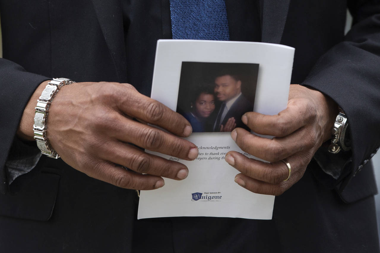 A person holds a program for the funeral service for Aaron Salter Jr. at The Chapel on Crosspoint o...