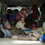 
              Two women sit inside a van as they are evacuated in Bakhmut, eastern Ukraine, Tuesday, May 24, 2022. The town of Bakhmut has been coming under increasing artillery strikes, particularly over the last week, as Russian forces try to press forward to encircle the city of Sieverodonetsk to the northeast. (AP Photo/Francisco Seco)
            