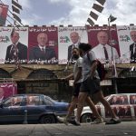 
              Campaign posters for former Lebanese Justice Minister and parliament candidate Ashraf Rifi, hang on a street in the northern city of Tripoli, Lebanon, Sunday, May 15, 2022. Lebanese voted for a new parliament Sunday against the backdrop of an economic meltdown that is transforming the country and low expectations that the election would significantly alter the political landscape. (AP Photo/Bilal Hussein)
            