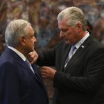 
              Mexican President Andrés Manuel López Obrador is decorated by his Cuban counterpart Miguel Diaz Canel with the Jose Marti order at Revolution Palace in Havana, Cuba, Sunday, May 8, 2022. (Yamil Lage/Pool Photo via AP)
            