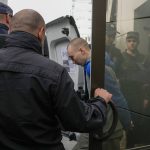 
              Police escort Russian Sgt. Vadim Shishimarin after a Ukrainian court sentenced him to life in prison in Kyiv, Ukraine, Monday, May 23, 2022. The court sentenced the 21-year-old soldier for killing a Ukrainian civilian, in the first war crimes trial held since Russia's invasion. (AP Photo/Natacha Pisarenko)
            