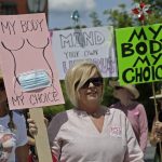 
              Abortion-rights demonstrators carry signs during a march on Saturday, May 14, 2022, in Chattanooga, Tenn. Demonstrators are rallying from coast to coast in the face of an anticipated Supreme Court decision that could overturn women’s right to an abortion. (AP Photo/Ben Margot)
            