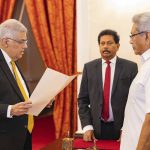 
              In this handout photograph provided by the Sri Lankan President's Office, President Gotabaya Rajapaksa, right, watches Ranil Wickremesinghe take the oath of office as the new prime minister in Colombo, Sri Lanka, Thursday, May 12, 2022. Wickremesinghe has been reappointed in an effort to bring stability to the island nation engulfed in a political and economic crisis. (Sri Lankan President's Office via AP)
            