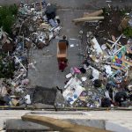 
              Residents carry out furniture from houses ruined by shelling in Borodyanka, Ukraine, Tuesday, May 24, 2022. (AP Photo/Natacha Pisarenko)
            