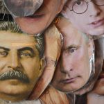 
              Face masks depicting Russian President Vladimir Putin, centre, Soviet dictator Josef Stalin, left, and and jailed Russian opposition leader Alexei Navalny, right, among others are displayed for sale at a street souvenir shop in St. Petersburg, Russia, Sunday, May 1, 2022. (AP Photo)
            