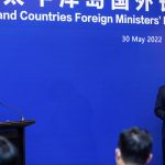 
              China's Foreign Minister Wang Yi, left, appears on stage at the Pacific Islands Foreign Ministers' meeting with Fiji's Prime Minister Frank Bainimarama, Monday, May 30, 2022, in Suva, Fiji. (Leon Lord/Fiji Sun via AP)
            