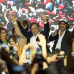 
              Presidential candidate Gustavo Petro, center, waves to supporters alongside his family on election night in Bogota, Colombia, Sunday, May 29, 2022. Petro will advance to a runoff contest in June after none of the six candidates in Sunday's first round got half the vote. (AP Photo/Fernando Vergara)
            