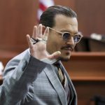 
              Actor Johnny Depp reacts as he leaves for a break in the courtroom in the Fairfax County Circuit Courthouse in Fairfax, Va., Thursday, May 26, 2022. Depp sued his ex-wife Amber Heard for libel in Fairfax County Circuit Court after she wrote an op-ed piece in The Washington Post in 2018 referring to herself as a "public figure representing domestic abuse." (Michael Reynolds/Pool Photo via AP)
            
