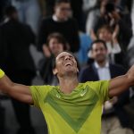 
              Spain's Rafael Nadal celebrates winning his quarterfinal match against Serbia's Novak Djokovic in four sets, 6-2, 4-6, 6-2, 7-6 (7-4), at the French Open tennis tournament in Roland Garros stadium in Paris, France, Wednesday, June 1, 2022. (AP Photo/Christophe Ena)
            