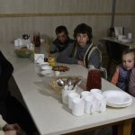 
              Children wait for a meal in the Orthodox Skete in honor of St. John of Shanghai in Adamivka, near Slovyansk, Donetsk region, Ukraine, Tuesday, May 10, 2022. (AP Photo/Andriy Andriyenko)
            