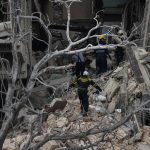 
              Rescue teams search for survivors at the site of a deadly explosion that destroyed the five-star Hotel Saratoga, in Havana, Cuba, Friday, May 6, 2022. A powerful explosion apparently caused by a natural gas leak killed at least 18 people, including a pregnant woman and a child, and injured dozens Friday when it blew away outer walls from the luxury hotel in the heart of Cuba’s capital. (AP Photo/Ramon Espinosa)
            