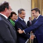 
              France's former President Francois Hollande, left, looks on as France's former President Nicolas Sarkozy, center, shakes hands with French President Emmanuel Macron during the ceremony of his inauguration for a second term at the Elysee palace, in Paris, France, Saturday, May 7, 2022. Macron was reelected for five years on April 24 in an election runoff that saw him won over far-right rival Marine Le Pen. (Gonzalo Fuentes/Pool via AP)
            