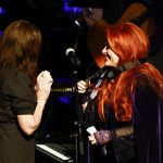 
              Wynonna Judd, right, shows her medallion to sister Ashley Judd during the Medallion Ceremony at the Country Music Hall of Fame on Sunday, May 1, 2022, in Nashville, Tenn. (Photo by Wade Payne/Invision/AP)
            