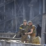 
              Ukrainian investigators work near a destroyed building on the outskirts of Odesa, Ukraine, Tuesday, May 10, 2022. The Ukrainian military said Russian forces fired seven missiles a day earlier from the air at the crucial Black Sea port of Odesa, hitting a shopping center and a warehouse. (AP Photo/Max Pshybyshevsky)
            