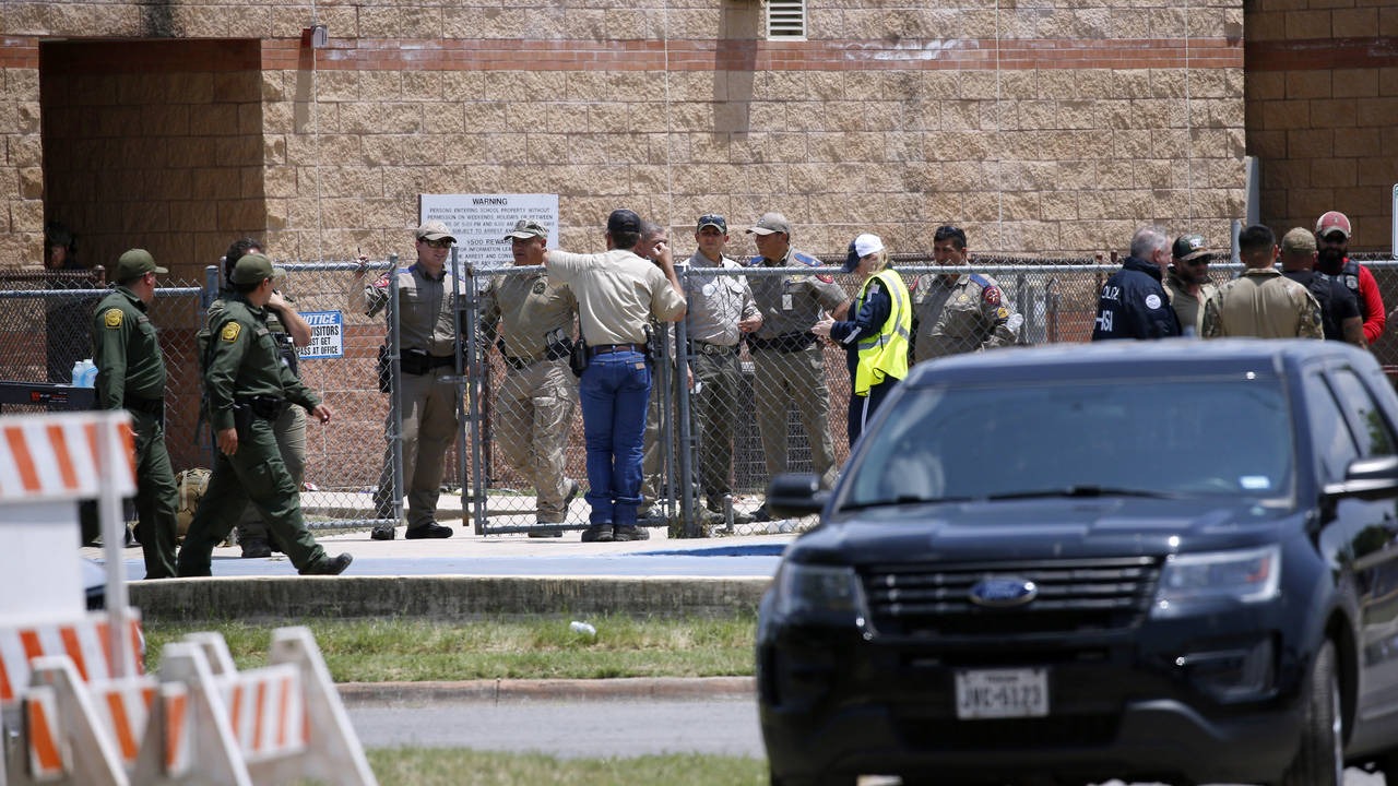 Law enforcement, and other first responders, gather outside Robb Elementary School following a shoo...