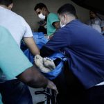 
              A person killed during a police raid of the Vila Cruzeiro favela is placed on a gurney at the Getulio Vargas Hospital, in Rio de Janeiro, Brazil, Tuesday, May 24, 2022. Police raided the favela before dawn Tuesday in an operation aimed at locating and arresting criminal leaders, prompting a fierce firefight. (AP Photo/Bruna Prado)
            