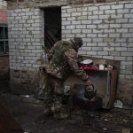
              A Ukrainian soldier heats water in a town north Derhachi, east Ukraine, Sunday, May 15, 2022. (AP Photo/Bernat Armangue)
            