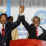 
              Hassan Sheikh Mohamud, right, marks his election win with incumbent leader Mohamed Abdullahi Mohamed, left, at the Halane military camp in Mogadishu, Somalia, Sunday, May 15, 2022. Former President Mohamud, who was voted out of power in 2017, has been returned to the nation's top office after defeating the incumbent leader in a protracted contest decided by legislators in a third round of voting late Sunday. (AP Photo/Farah Abdi Warsameh)
            