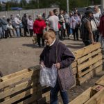 
              People queue to receive flour at a food donation spot in Kharkiv, eastern Ukraine, Monday, May 23, 2022. (AP Photo/Bernat Armangue)
            