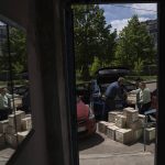 
              Volunteers unload humanitarian aid for elderly people in Bahmut, Ukraine, on Thursday, May 12, 2022. (AP Photo/Evgeniy Maloletka)
            