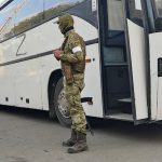 
              A Russian serviceman guards a bus with Ukrainian servicemen after they were evacuated from the besieged Mariupol's Azovstal steel plant, near a remand prison in Olyonivka, in a territory under the government of the Donetsk People's Republic control, eastern Ukraine, Tuesday, May 17, 2022. More than 260 fighters, some severely wounded, were pulled from a steel plant on Monday that is the last redoubt of Ukrainian fighters in the city and transported to two towns controlled by separatists, officials on both sides said. (AP Photo/Alexei Alexandrov)
            