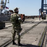 
              A Russian serviceman guards an area during the loading off rolled steel onto a Russian vessel at the Mariupol Sea Port in Mariupol, in territory under the government of the Donetsk People's Republic, eastern Ukraine, Monday, May 30, 2022. It marked the first time that a commercial ship used the port of Mariupol since the start of the Russian military action in Ukraine. (AP Photo)
            