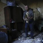 
              A local resident gathers up belongings from his heavily damaged house after a Russian strike in Pokrovsk, eastern Ukraine, Wednesday, May 25, 2022. Two rockets struck the eastern Ukrainian town of Pokrovsk, in the Donetsk region early Wednesday morning, causing at least four injuries. (AP Photo/Francisco Seco)
            