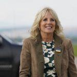 
              First Lady Jill Biden wears a large Ukrainian pin on her jacket as she walks toward her plane at Koscice International Airport in Kosice, Slovakia, Sunday, May 8, 2022. Biden spent part of her day visiting with Olena Zelenska, spouse of Ukrainian's President Volodymyr Zelenskyy, in Ukraine. An aide said she received the pin from the head of Mrs. Zelenska's security detail after she gave him one of her challenge coins. (AP Photo/Susan Walsh, Pool)
            