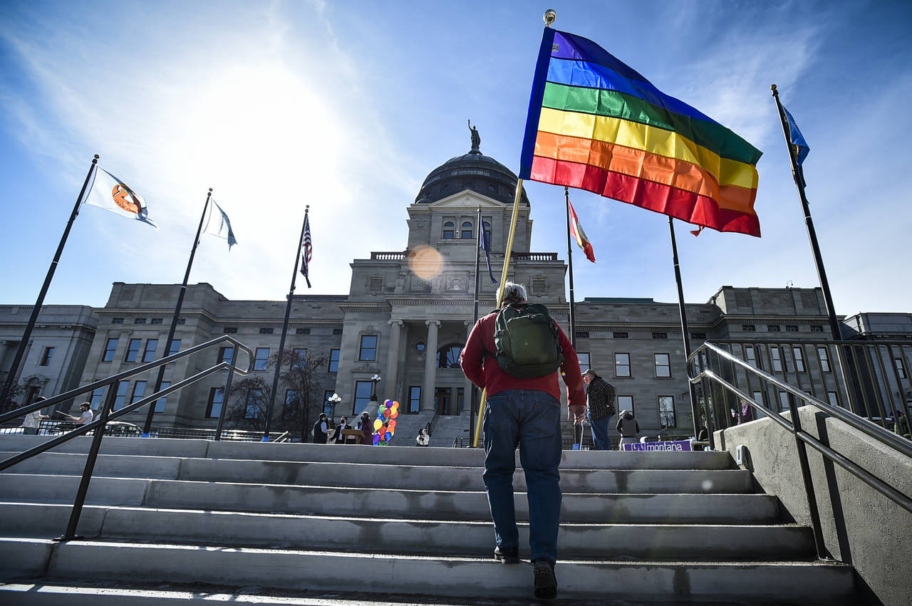 FILE - In this March 15, 2021, file photo, demonstrators gather on the steps of the Montana State C...