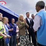 
              First lady Jill Biden speaks as she talks with a United Nations Refugee Agency worker during a visit to Vysne Nemecke, Slovakia, near the border with Ukraine, Sunday, May 8, 2022. Slovakia's Prime Minister Eduard Heger stands next to Biden at right. (AP Photo/Susan Walsh, Pool)
            