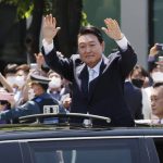 
              South Korea's new President Yoon Suk Yeol waves from a car after the Presidential Inauguration outside the National Assembly in Seoul, South Korea, Tuesday, May 10, 2022. (Ha Sa-hun/Yonhap via AP)
            