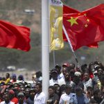 
              FILE - Spectators hold a Chinese flag as they watch a ceremony to mark the opening of Independence Drive Boulevard in Port Moresby, Papua New Guinea, Friday, Nov. 16, 2018. China wants 10 small Pacific nations to endorse a sweeping agreement covering everything from security to fisheries in what one leader warns is a “game-changing” bid by Beijing to wrest control of the region. (AP Photo/Mark Schiefelbein, Pool, File)
            