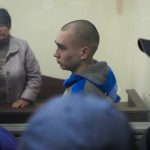 
              Russian army Sergeant Vadim Shishimarin, 21, is seen behind a glass during a court hearing in Kyiv, Ukraine, Wednesday, May 18, 2022. The Russian soldier has gone on trial in Ukraine for the killing of an unarmed civilian. The case that opened in Kyiv marked the first time a member of the Russian military has been prosecuted for a war crime since Russia invaded Ukraine 11 weeks ago. (AP Photo/Efrem Lukatsky)
            