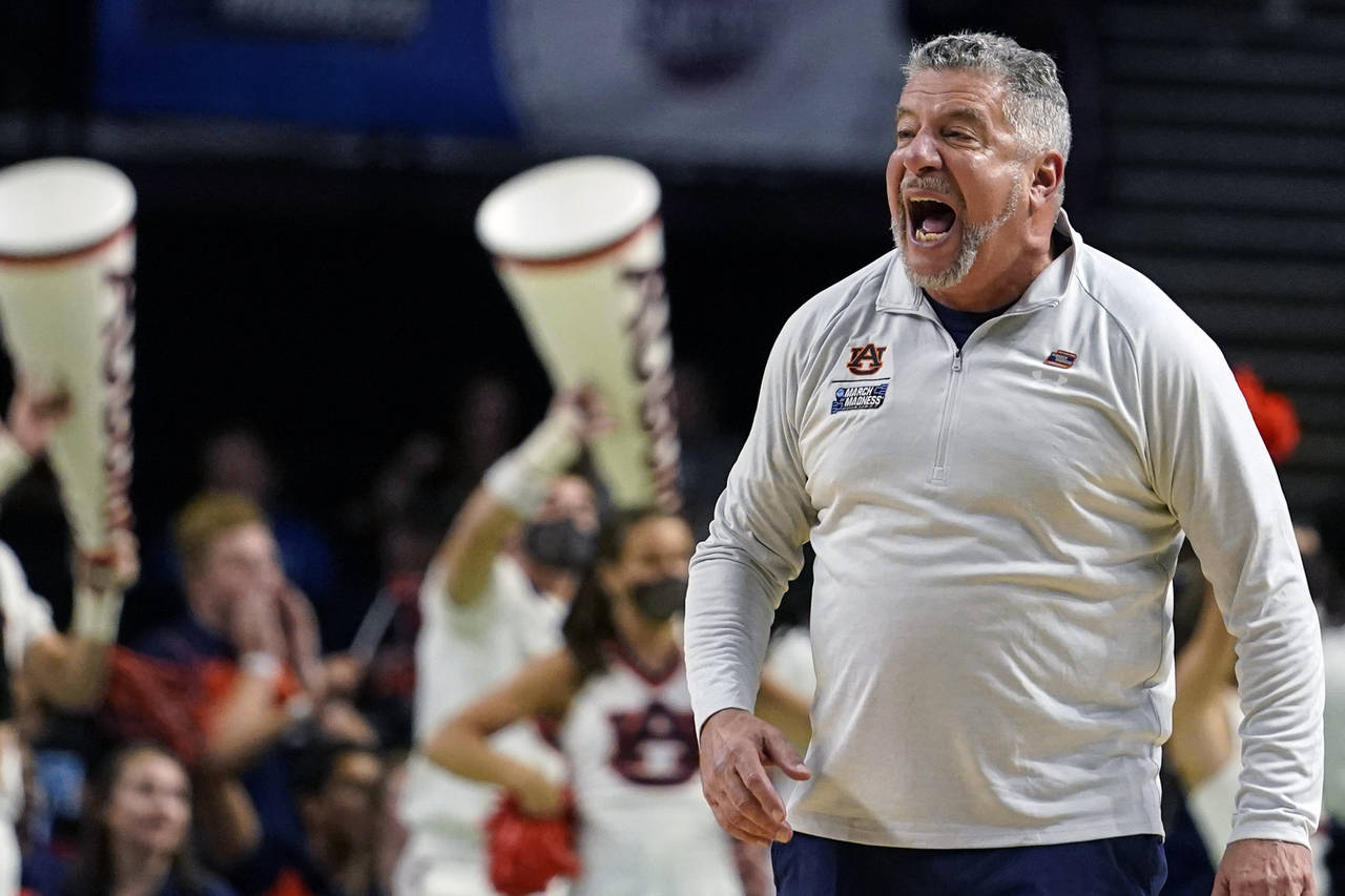 Auburn head coach Bruce Pearl yells towards his players during the first half of a college basketba...