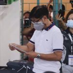 
              Presidential candidate Ferdinand Marcos Jr., the son of the late dictator, looks at the receipt after voting at a polling center in Batac City, Ilocos Norte, northern Philippines on Monday, May 9, 2022. Filipinos were voting for a new president Monday, with the son of an ousted dictator and a champion of reforms and human rights as top contenders in a tenuous moment in a deeply divided Asian democracy. (AP Photo)
            