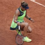 
              FILE - Japan's Naomi Osaka stretches her left foot as she plays against Amanda Anisimova of the U.S. during their first round match at the French Open tennis tournament in Roland Garros stadium in Paris, France, Monday, May 23, 2022. Naomi Osaka's 2022 French Open is done following a first-round loss. The players remaining in the tournament see and hear products of her frank discussion about anxiety and depression a year ago -- from new "quiet rooms" and on-call psychiatrists at Roland Garros to a broader sense that mental health is a far-less-taboo topic than it once was. (AP Photo/Christophe Ena, File)
            