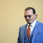 
              Actor Johnny Depp stands in the courtroom at the Fairfax County Circuit Courthouse in Fairfax, Va., Tuesday, May 24, 2022. Depp sued his ex-wife Amber Heard for libel in Fairfax County Circuit Court after she wrote an op-ed piece in The Washington Post in 2018 referring to herself as a "public figure representing domestic abuse." (Jim Watson/Pool photo via AP)
            