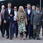 
              First lady Jill Biden speaks with Slovakia's Prime Minister Eduard Heger as she walks from Vysne Nemecke, Slovakia, towards the border with Ukraine, red line, during a visit Sunday, May 8, 2022. (AP Photo/Susan Walsh, Pool)
            