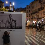 
              A young boy looks at a pictures of late French actor Jean-Paul Belmondo, in Cannes, France, Friday, May 13, 2022. The 75th Cannes Film Festival will take place from May 17-28. (AP Photo/Petros Giannakouris)
            