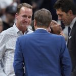
              Former NFL quarterback Peyton Manning, left, chats with Joe Lacob, majority owner of the Golden State Warriors, during a timeout in the second half of Game 3 of an NBA basketball first-round Western Conference playoff series between the Warriors and the Denver Nuggets on Thursday, April 21, 2022, in Denver. (AP Photo/David Zalubowski)
            