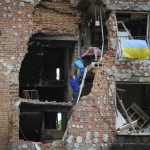 
              Residents take out their belongings from their house ruined by the Russian shelling in Irpin close to Kyiv, Ukraine, Saturday, May 21, 2022. (AP Photo/Efrem Lukatsky)
            