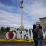 
              A couple kiss in downtown Kyiv, Ukraine, Wednesday, May 25, 2022. (AP Photo/Natacha Pisarenko)
            
