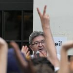 
              Hard-left leader Jean-Luc Melenchon speaks to supporters outside his election night headquarters, Sunday, June 19, 2022 in Paris. French President Emmanuel Macron's alliance got the most seats in the final round of the parliamentary election on Sunday, but it lost its parliamentary majority, projections show. (AP Photo/Michel Euler)
            