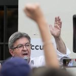 
              Hard-left leader Jean-Luc Melenchon speaks to supporters outside his election night headquarters, Sunday, June 19, 2022 in Paris. French President Emmanuel Macron's alliance got the most seats in the final round of the parliamentary election on Sunday, but it lost its parliamentary majority, projections show. (AP Photo/Michel Euler)
            