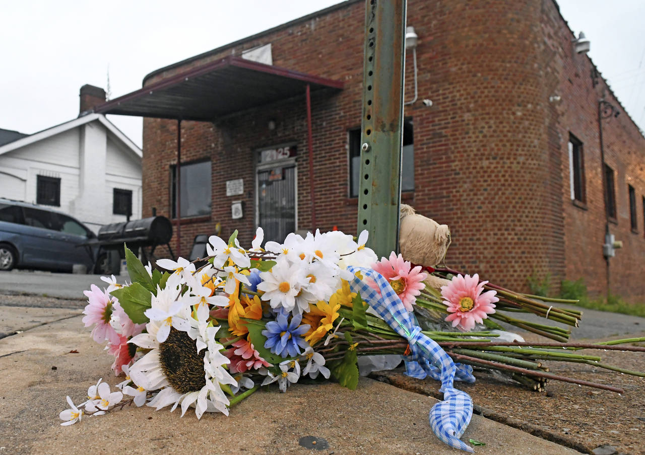A makeshift memorial sits at the base of a street sign outside Mary's Bar and Grill, Tuesday, June ...