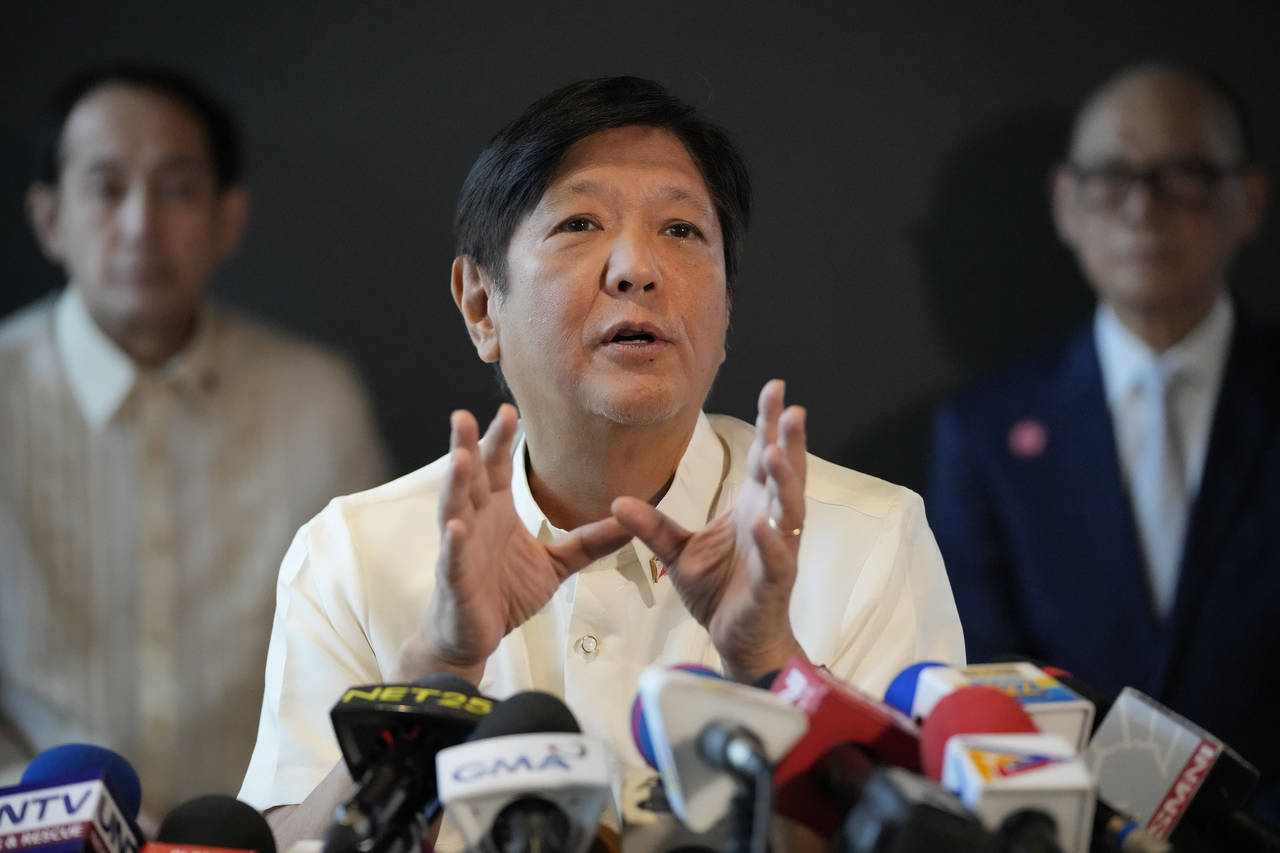 Philippine President-elect Ferdinand "Bongbong" Marcos Jr., center, gestures during a press confere...
