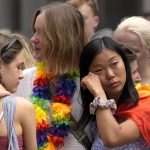 
              Women react as they stand at the scene of a shooting in central Oslo, Norway, Saturday, June 25, 2022. A gunman who opened fire in Oslo’s nightlife district has killed two people and left more than 20 others injured during the LGBTQ Pride festival in Norway's capital. (AP Photo/Sergei Grits)
            