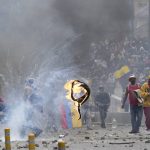 
              Demonstrators clash with police during protests against the government of President Guillermo Lasso and rising fuel prices, in Quito, Ecuador, Tuesday, June 21, 2022. Ecuador's defense minister warned Tuesday that the country's democracy was at risk as demonstrations turned increasingly violent in the capital. (AP Photo/Dolores Ochoa)
            